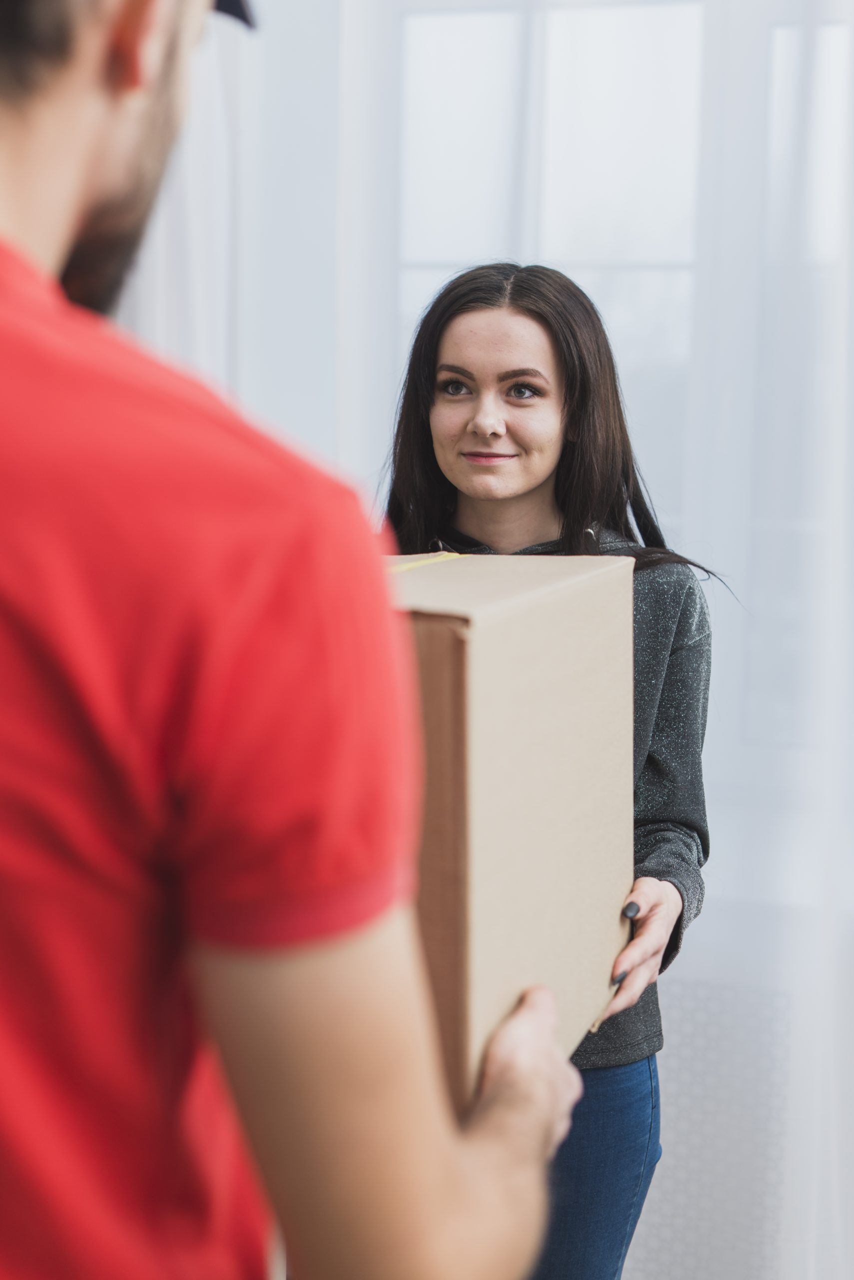 woman receiving parcel with courier